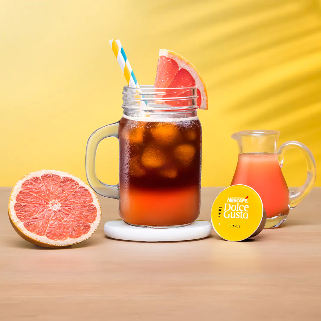 iced grapefruit next to a coffee capsule